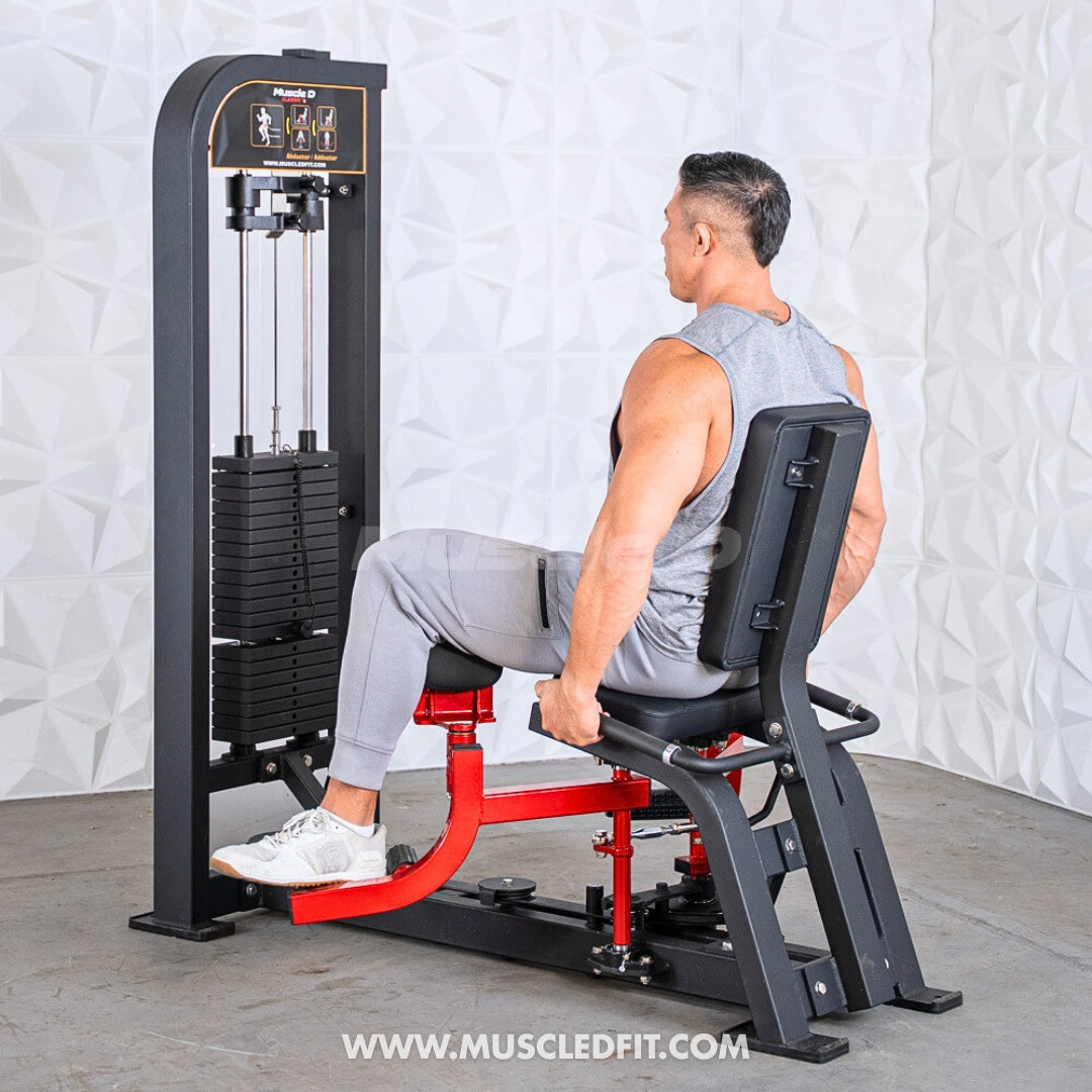 Man using a black and red inner/outer thigh combo machine with a weight stack.