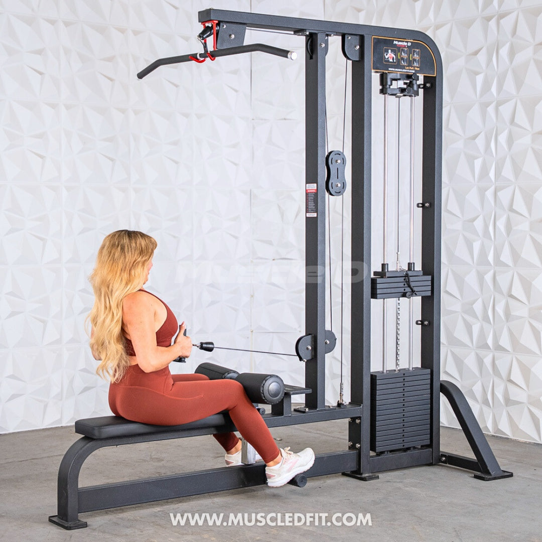Woman in a red sports bra and leggings performing a low row exercise on a black lat pulldown/low row machine.