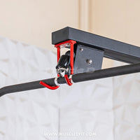 Thumbnail for Close-up of a black lat pulldown bar with red hooks attached to a pulley system.