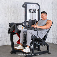 Thumbnail for Man using a black and red leg extension/curl machine with weight stack.