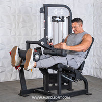 Thumbnail for Man performing leg extension on a black selectorized leg extension/curl machine with white textured wall background.