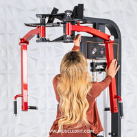 Thumbnail for Woman with long blonde hair adjusting the red arms of a black pec/rear delt combo machine.