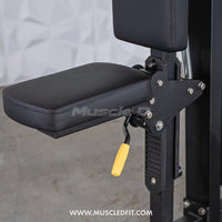 Thumbnail for Close-up of a black padded seat with a yellow adjustment handle on a fitness machine.