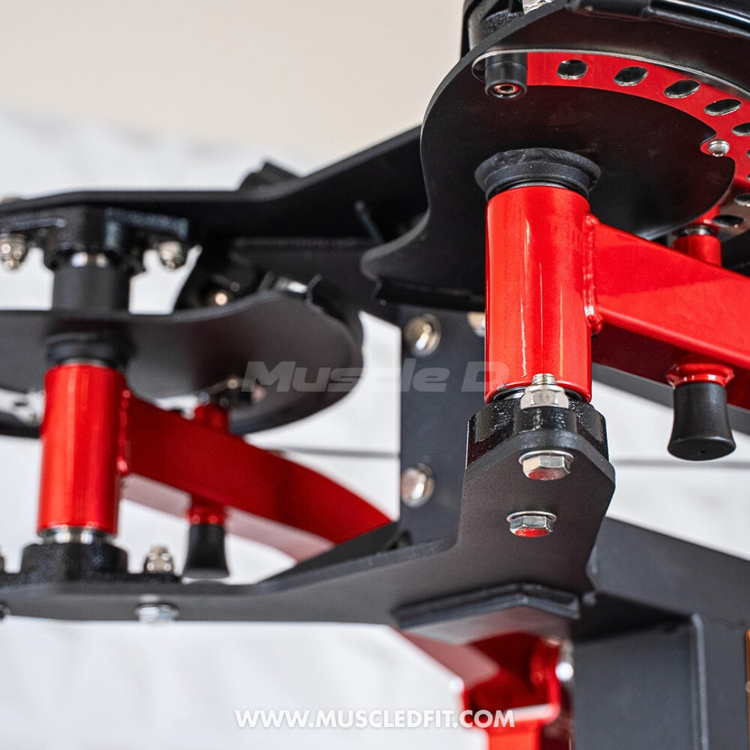 Close-up of red and black fitness machine components, showing bolts, nuts, and a "Muscle D" logo.