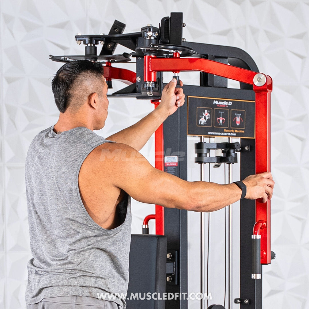 Man adjusting the settings on a red and black pec/rear delt combo machine.