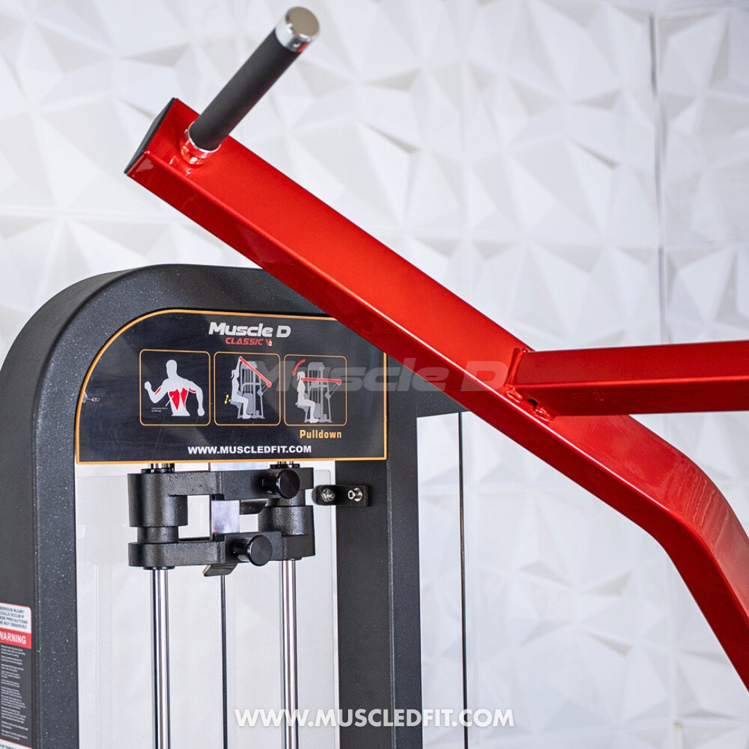Close-up of a red and black lat pulldown machine with exercise instructions and "Muscle D Classic" branding.