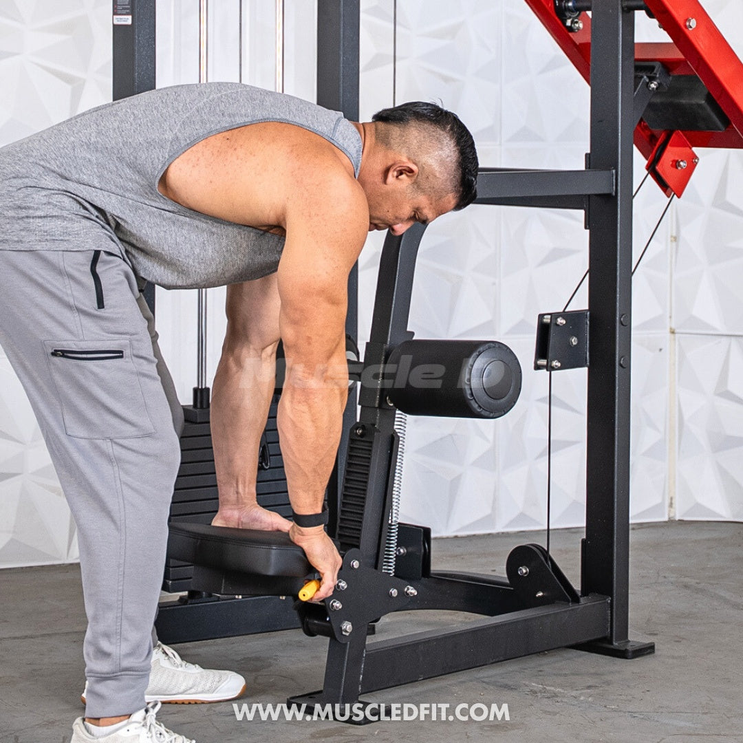 Man adjusting the leg pad on a black selectorized seated lat pull machine.