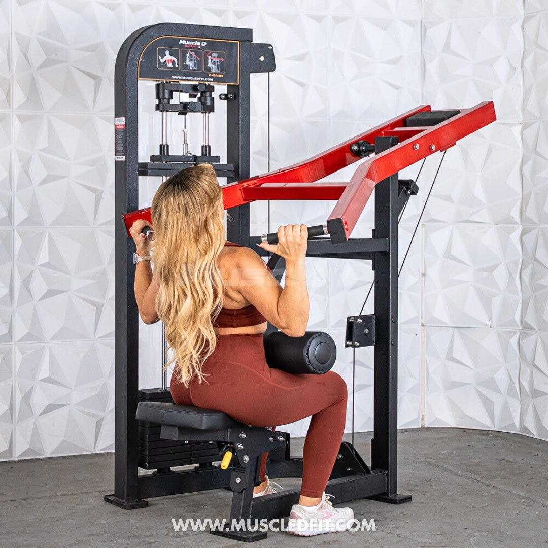 Woman using a black and red selectorized seated lat pull machine.