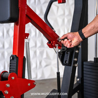 Thumbnail for Close-up of a person's hand adjusting a pin on a red and black seated row machine.