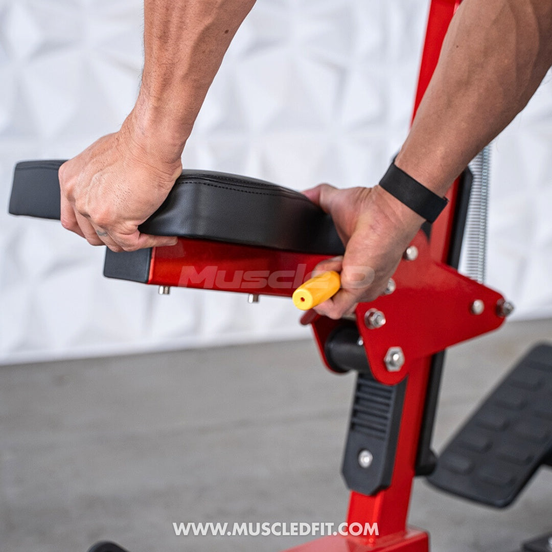 Hands adjusting the black padded seat and yellow pin on a red seated row machine.