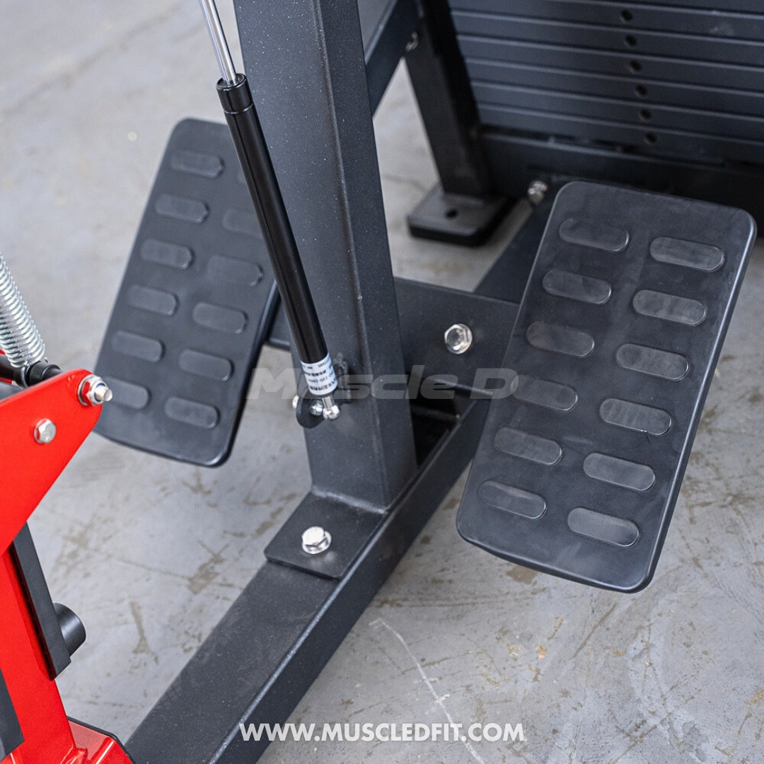 Close-up of the textured footplates and hydraulic cylinder on a seated row machine.