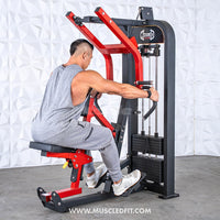 Thumbnail for Man in a gray tank top using a red and black seated row machine with a weight stack.