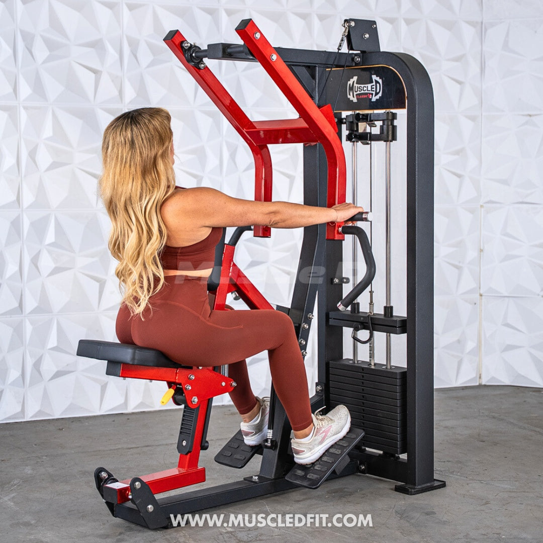 Woman using a red and black seated row machine with multi-grip handles and weight stack.