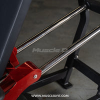 Thumbnail for Close-up of a leg press machine with chrome guide rods, red pivot points, and black frame.