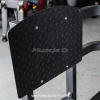 Thumbnail for Close-up of a black diamond plate foot platform on a leg press machine.