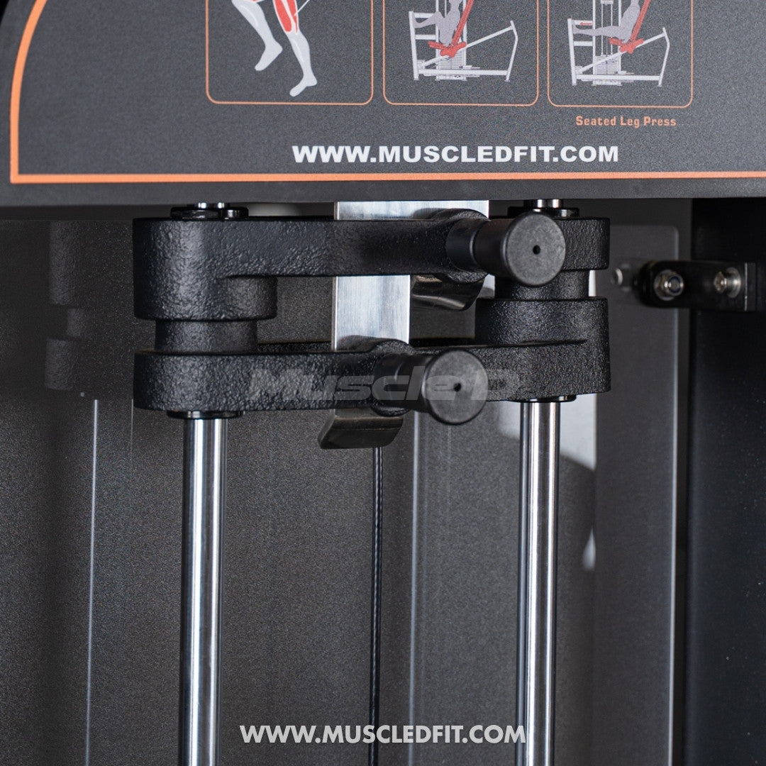 Close-up of the selectorized pin and weight stack guide rods on a leg press machine.