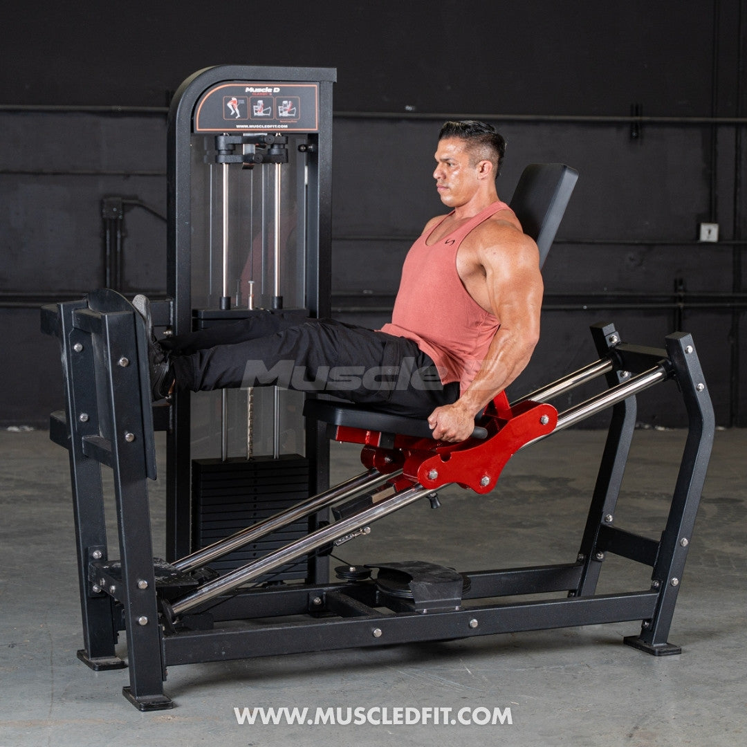 Man using a black and red selectorized leg press machine with a 300lb weight stack.