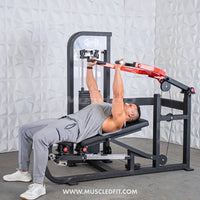 Thumbnail for Man using a red and black multi-press chest and shoulder machine with a weight stack.