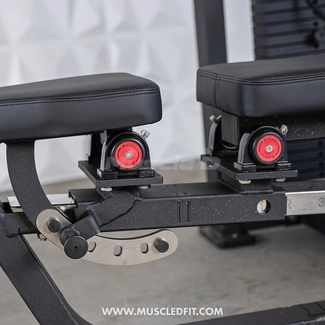 Close-up of black padded seats with red rotation knobs and a silver adjustment lever on a multi-press machine.