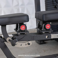 Thumbnail for Close-up of black padded seats with red rotation knobs and a silver adjustment lever on a multi-press machine.