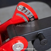 Thumbnail for Close-up of the red adjustment mechanism on a black multi-press machine.