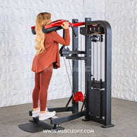 Thumbnail for Woman using a black and red selectorized standing calf raise machine with weight stack.