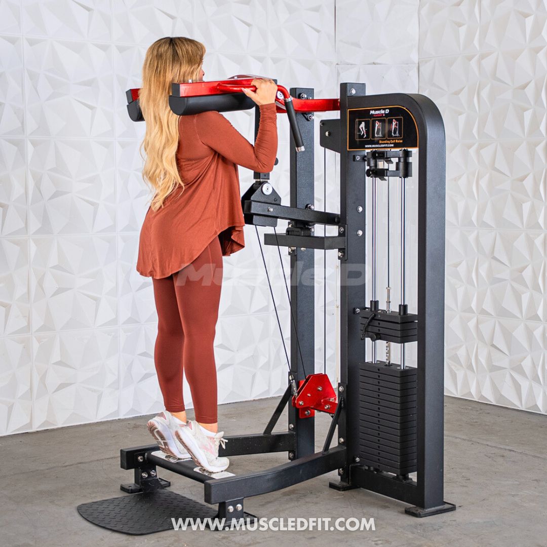 Woman using a black and red selectorized standing calf raise machine with a weight stack.