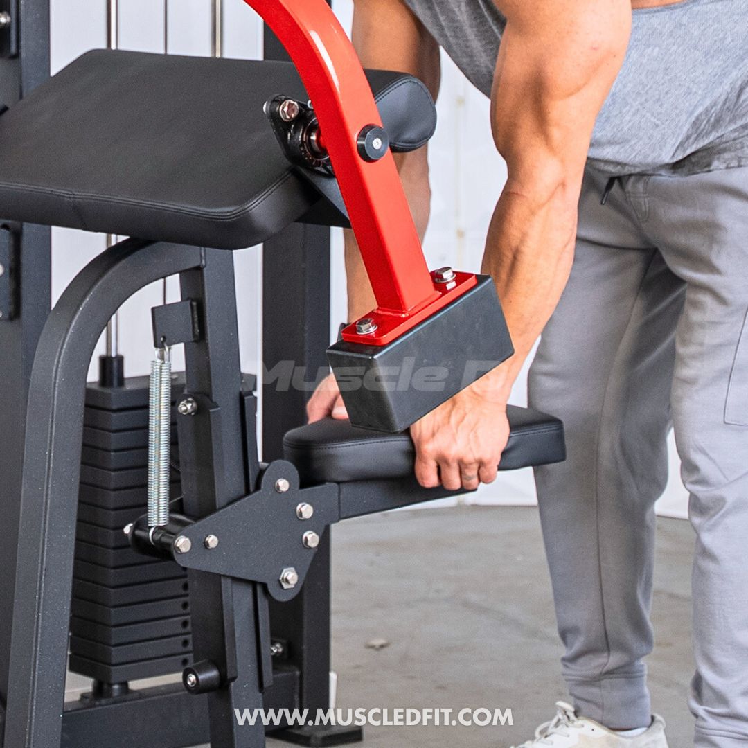 Man adjusting the seat of a black and red biceps/triceps combo gym machine.