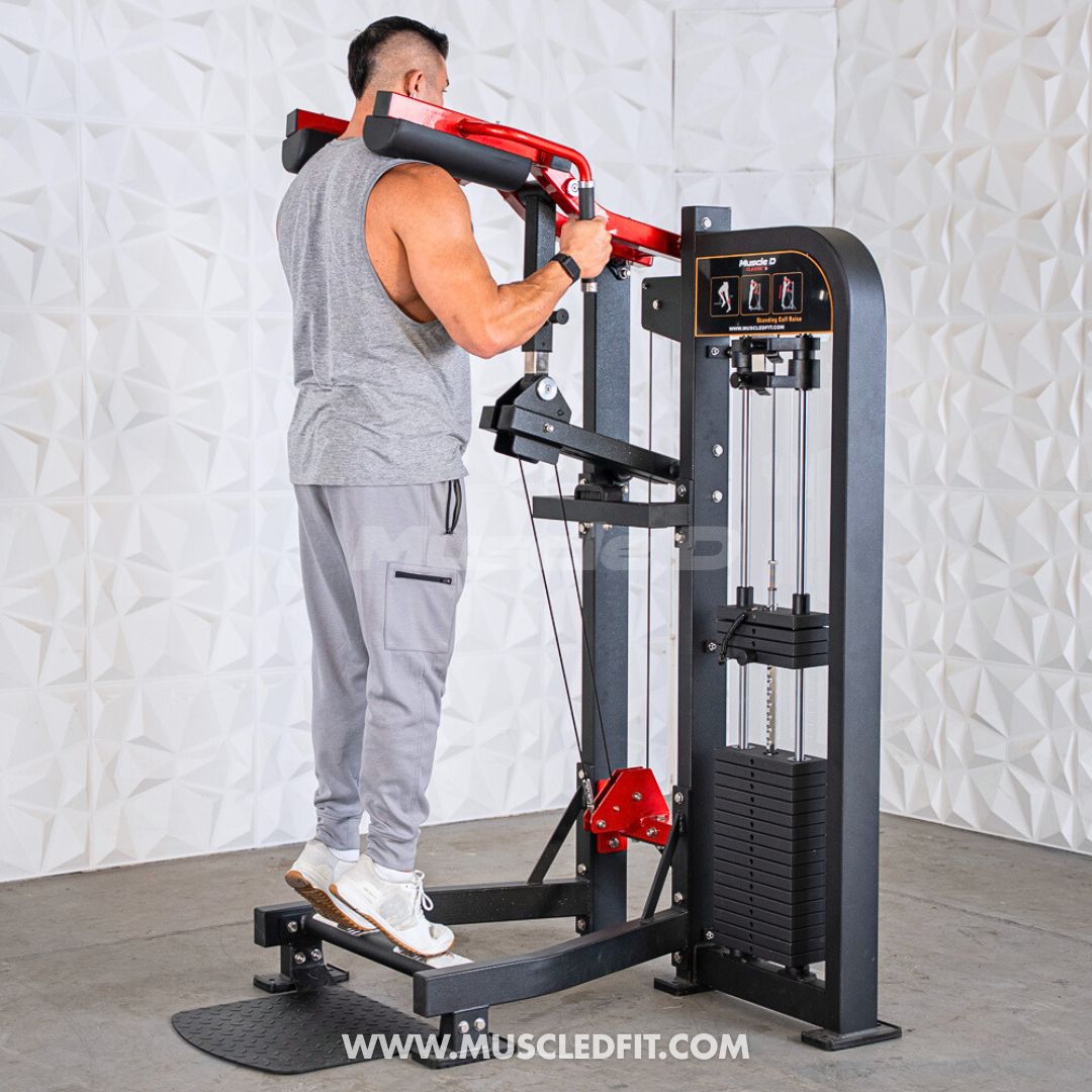Man using a black and red selectorized standing calf raise machine with weight stack.