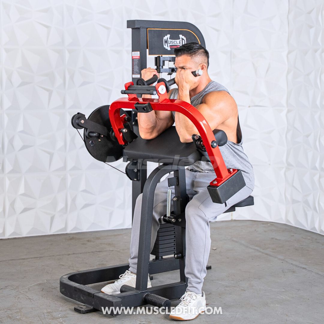 Man in a grey tank top and sweatpants using a red and black biceps/triceps combo gym machine.