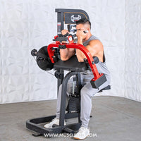 Thumbnail for Man in a grey tank top and sweatpants using a red and black biceps/triceps combo gym machine.