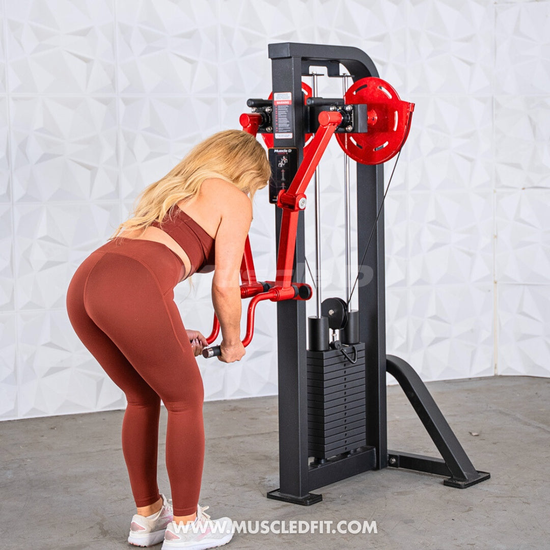Woman using a black and red lateral raise machine with a weight stack.