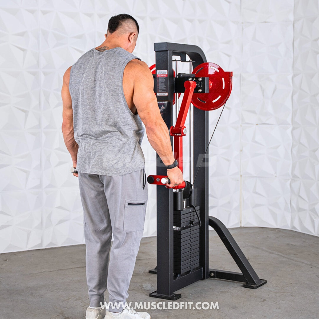 Man in grey tank top and pants using a black and red lateral raise machine.