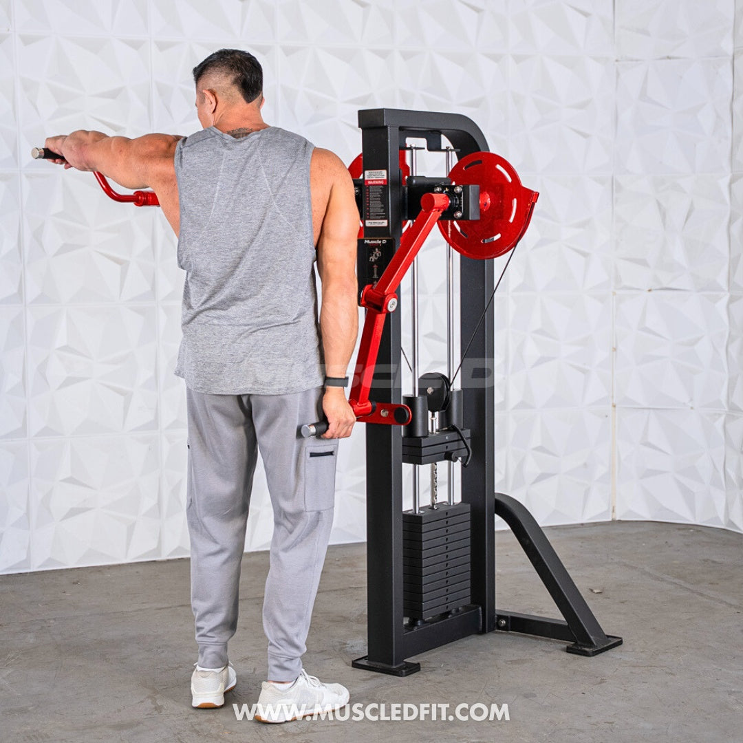 Man using a black and red lateral raise machine with a weight stack.