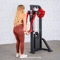 Thumbnail for Woman using a black and red lateral raise machine with a weight stack.