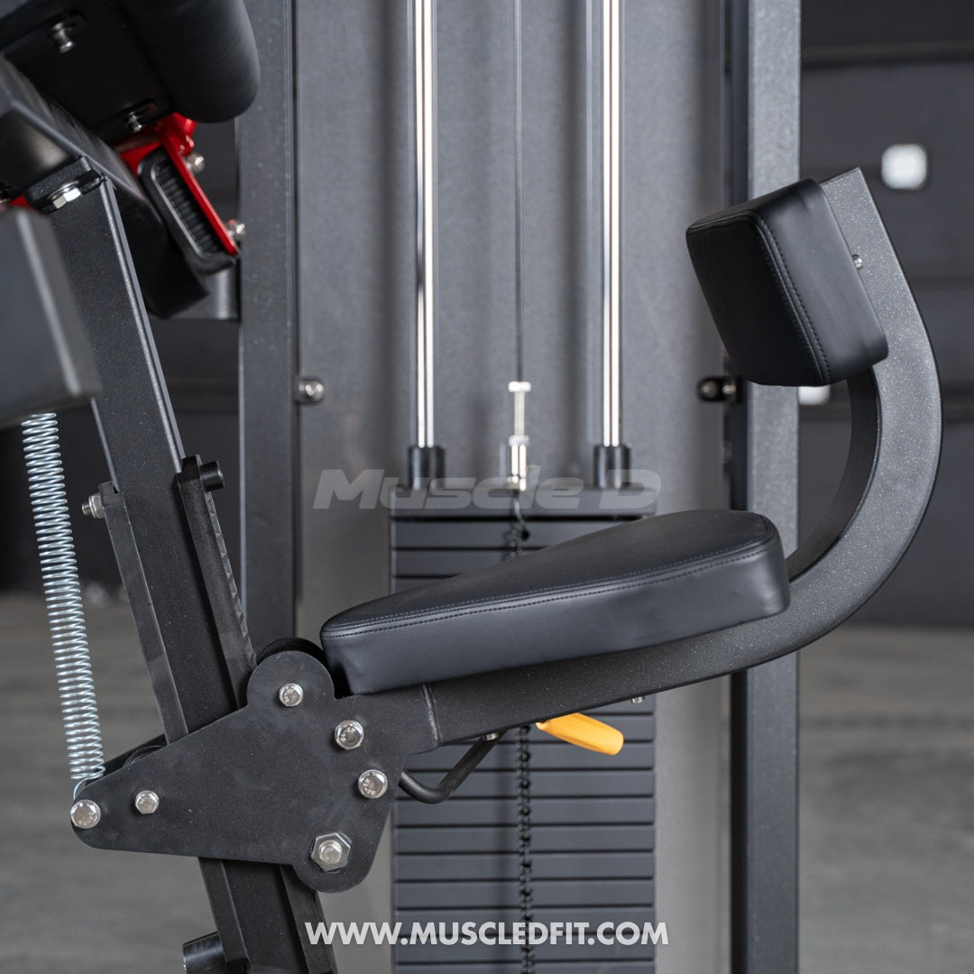Close-up of a black commercial triceps extension machine with a padded seat and backrest, and weight stack.