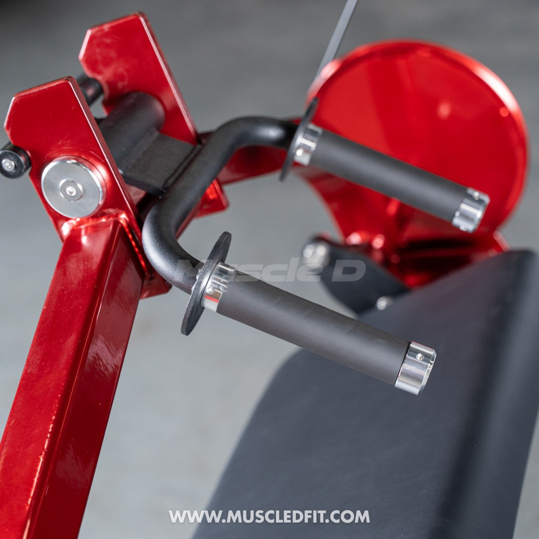 Close-up of a red triceps extension machine with black handles and a black seat.