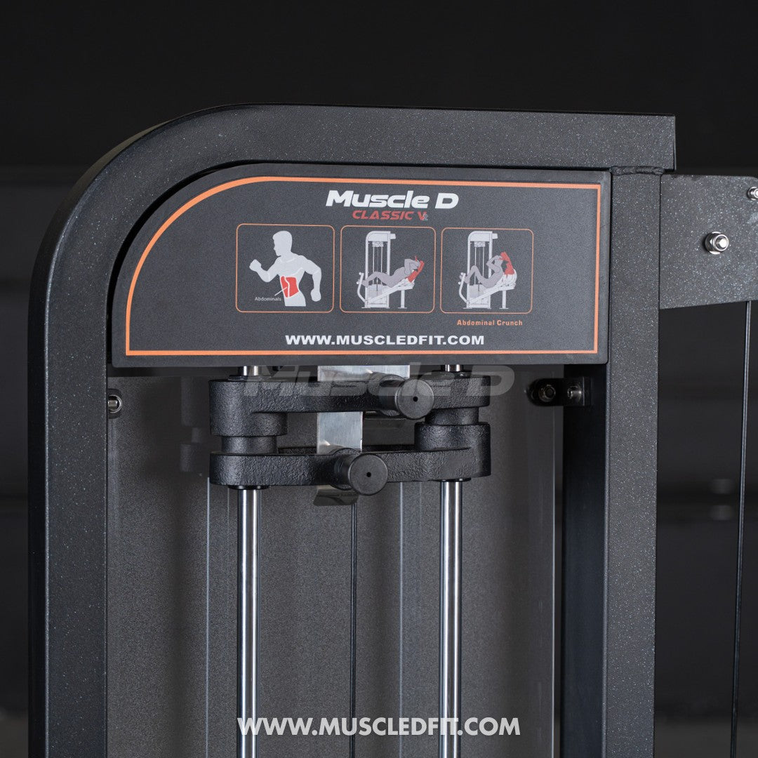 Close-up of Muscle D Classic V2 abdominal crunch machine with exercise diagram and website.