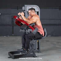 Thumbnail for Man using a red and black triceps extension machine in a gym.
