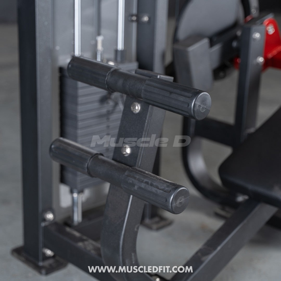Close-up of the black handles and weight stack on a selectorized abdominal crunch machine.