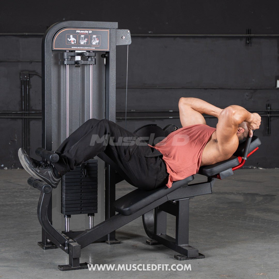 Man performing an abdominal crunch on a selectorized gym machine.