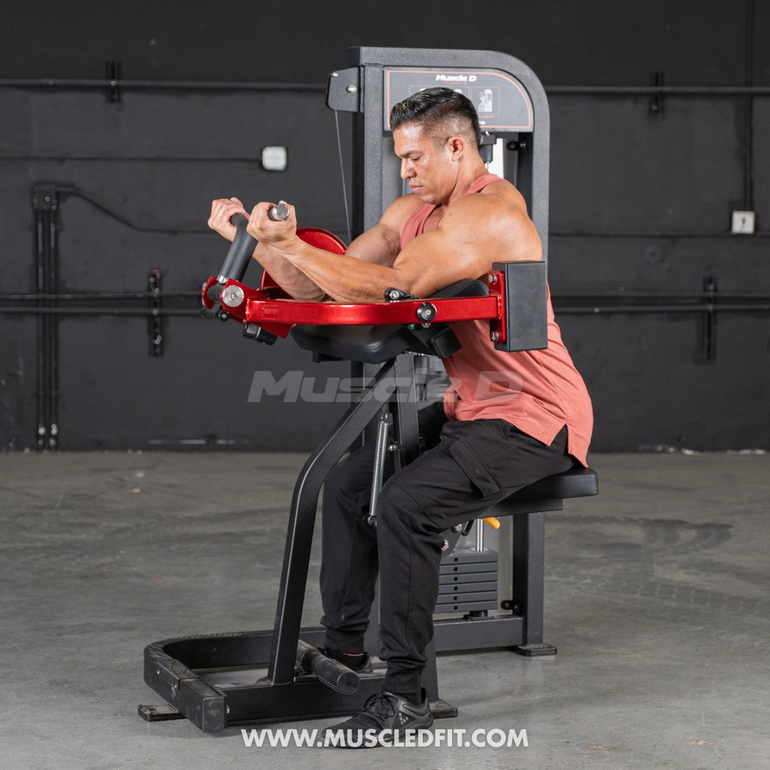 Man using a red and black biceps curl machine with a weight stack.