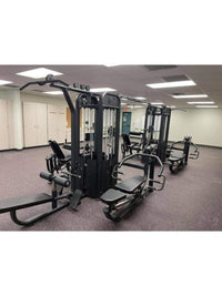 Thumbnail for Black 8-stack multi-gym with various exercise stations in a well-lit room with white cabinets.