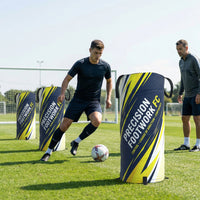Thumbnail for Soccer player dribbling past custom pop-up defenders on a field, coach watching.
