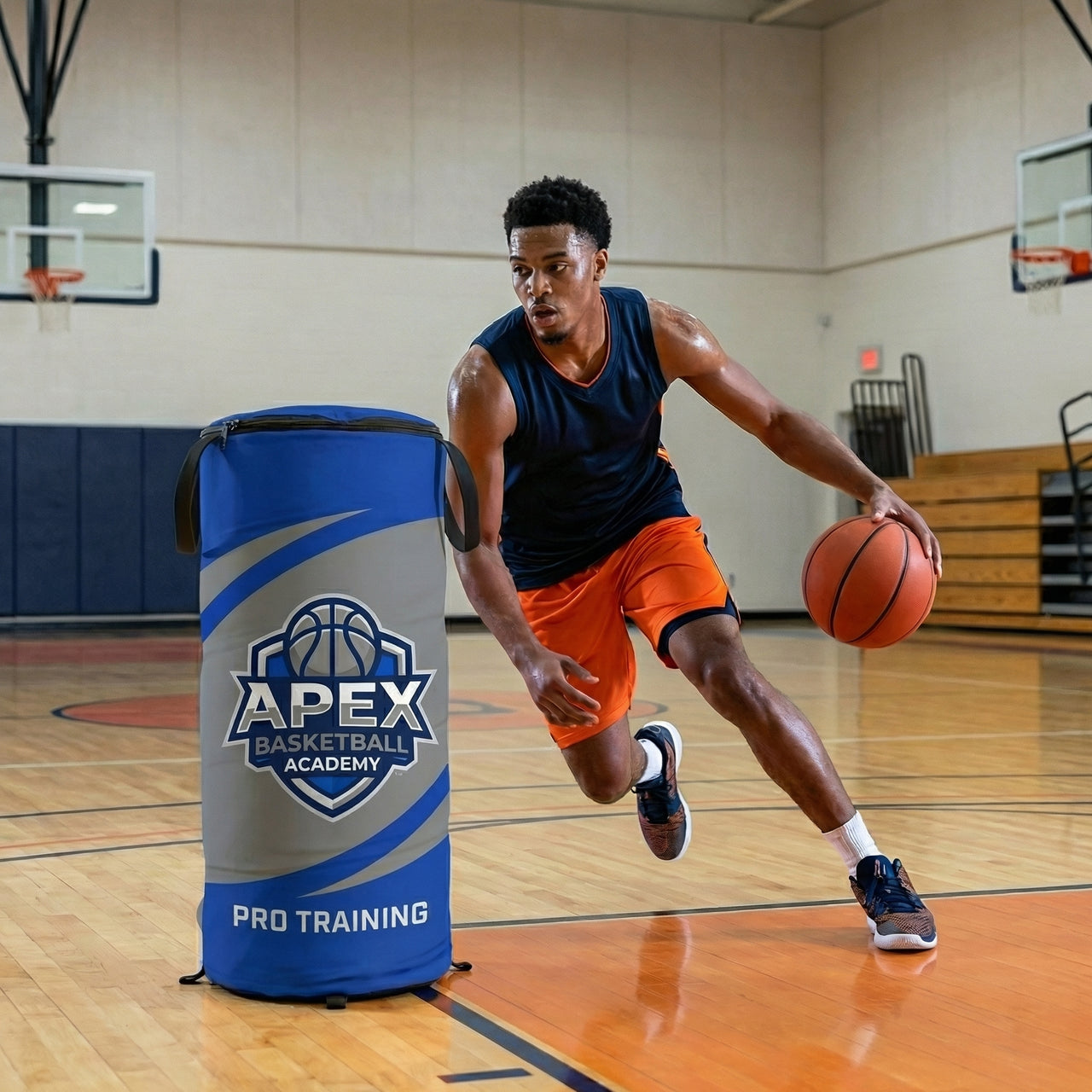 Basketball player dribbling past a custom blue and gray pop-up defender with a logo on a court.