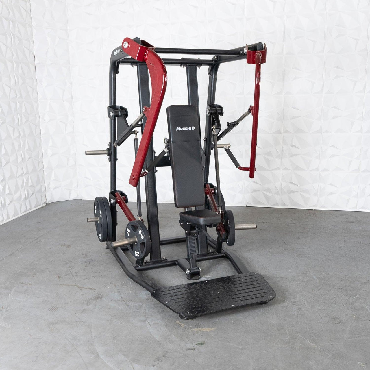 Black and red plate-loaded chest press machine with a black seat and footplate.