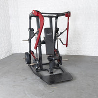 Thumbnail for Black and red plate-loaded chest press machine with a black seat and footplate.