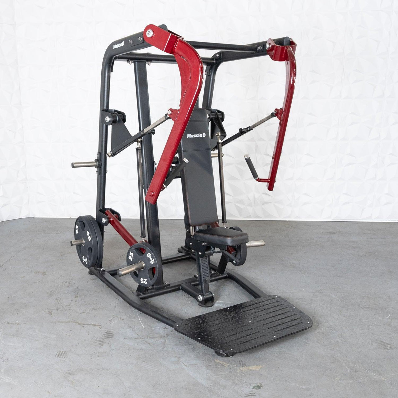 Black and red plate-loaded chest press machine with an adjustable bench and footplate.