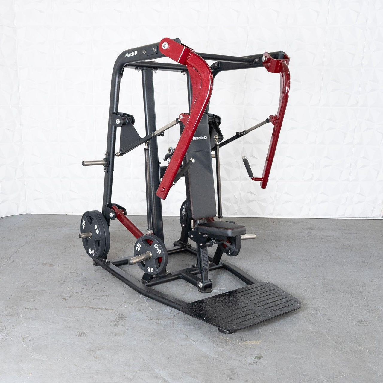 Black and red plate-loaded chest press machine with a padded seat and foot platform.