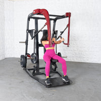 Thumbnail for Woman in pink using a black and red plate-loaded chest press machine.